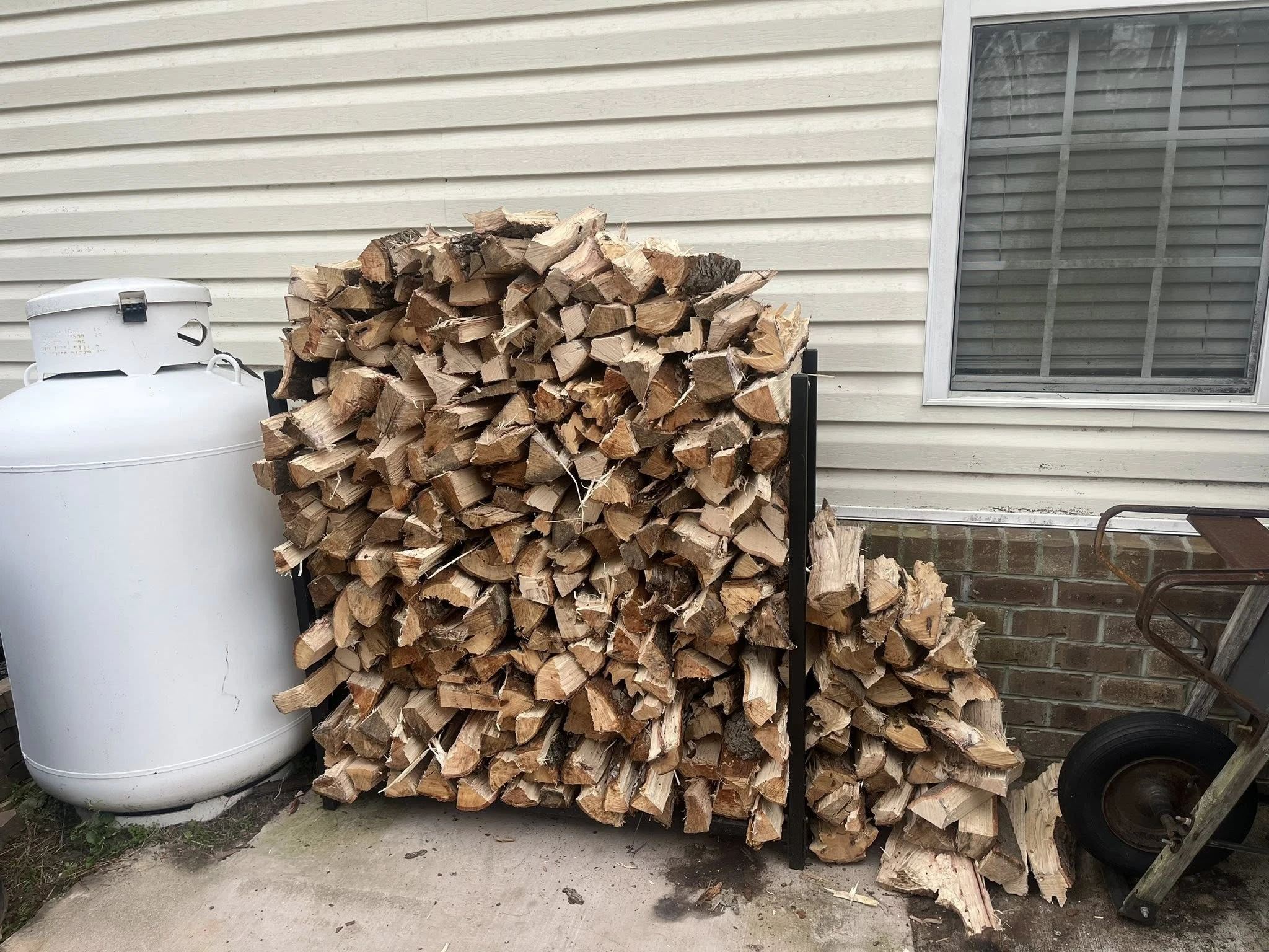 Delivered firewood stacked at a residential property